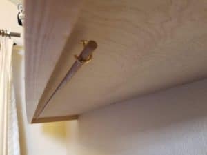 Dowel under shelf to add hanging storage