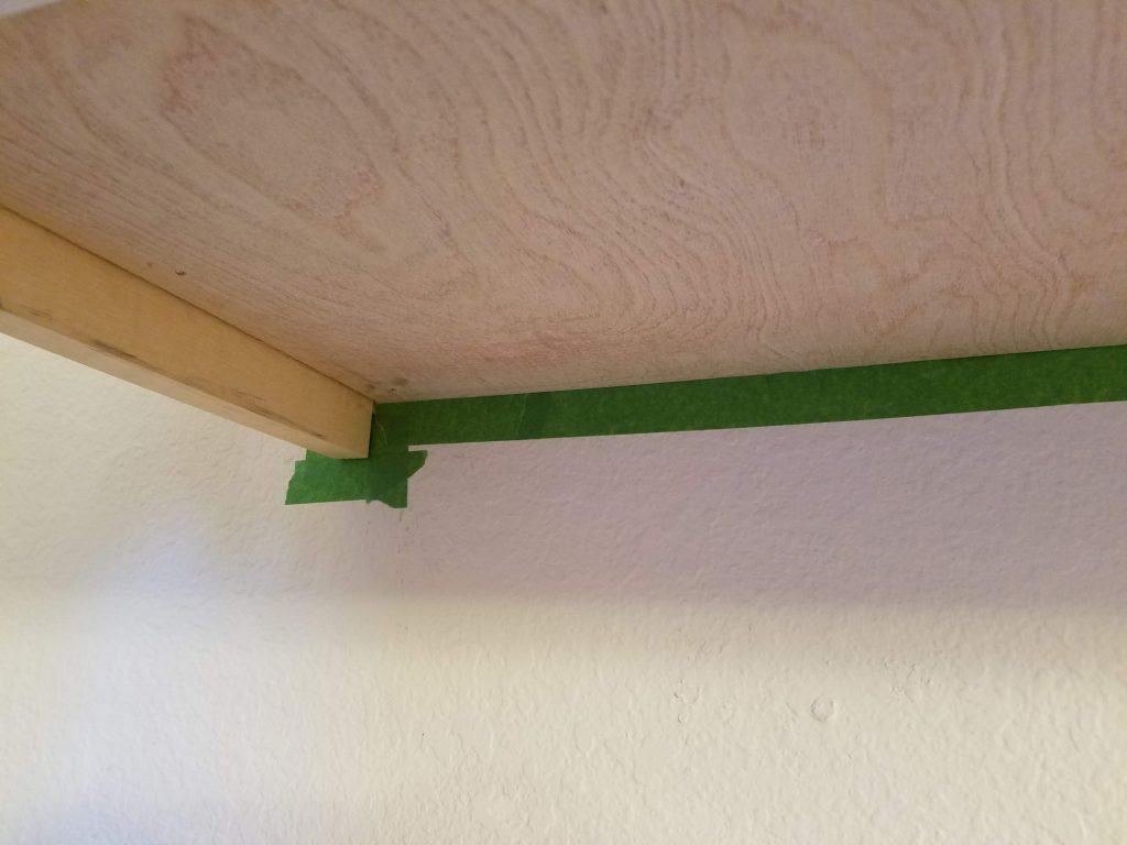 How to stain shelves - painters' tape applied around shelves